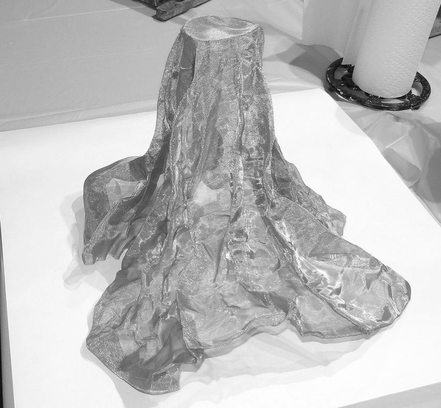 Miracle Mesh draped over a tall vessel to create a fluid form